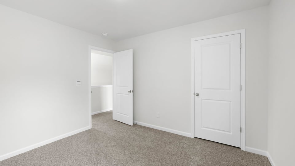 Bedroom with carpet and window.