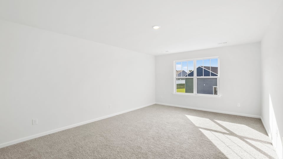 Bedroom with carpet and window.