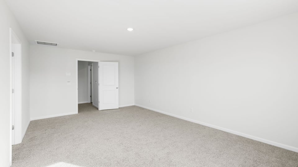Bedroom with carpet and window.