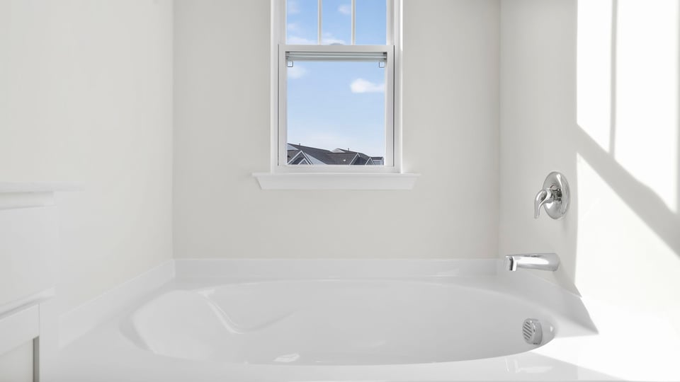 Bathroom with tub and window.