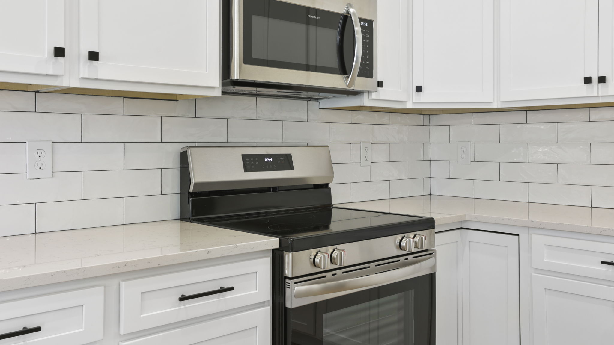 Kitchen and island with stainless steel appliances.