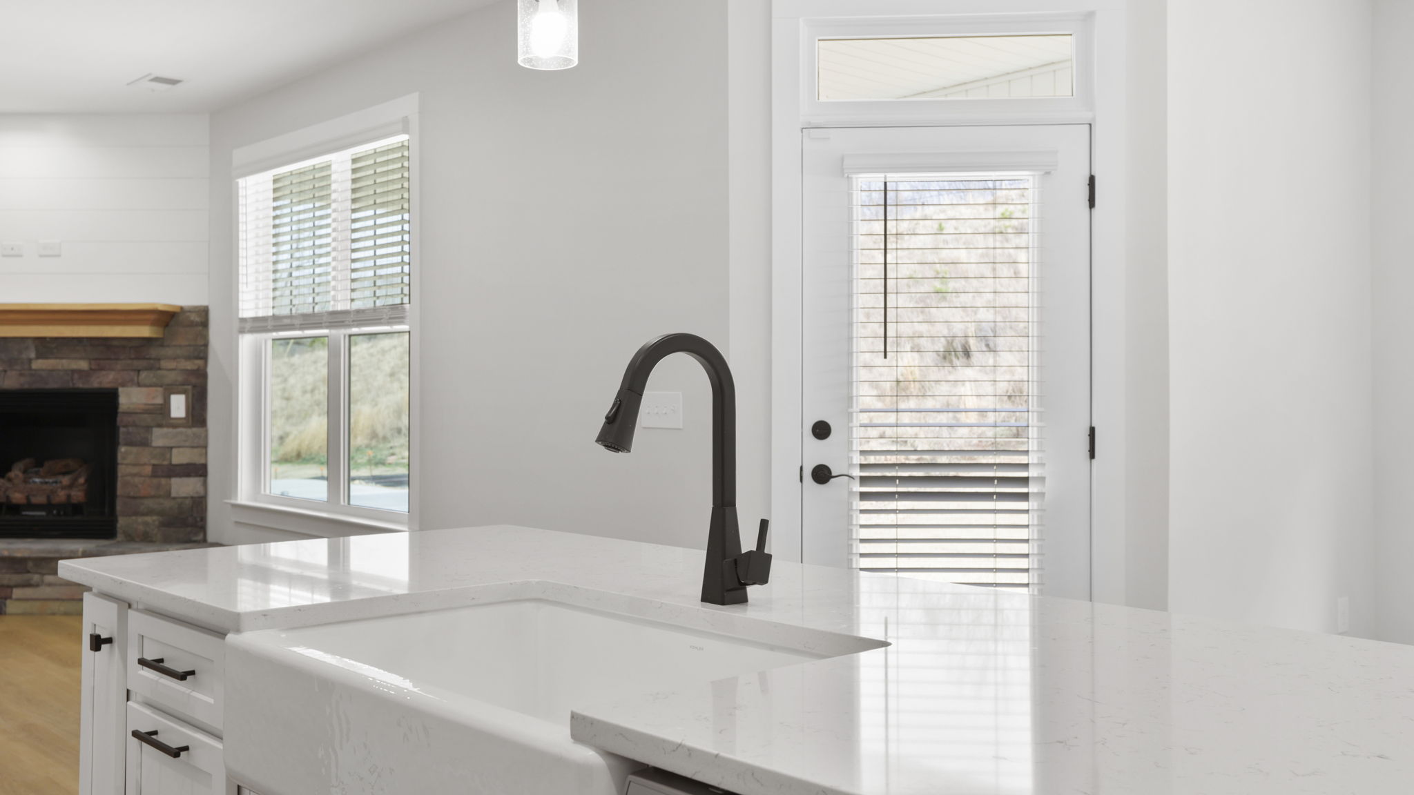 Kitchen and island with stainless steel appliances.