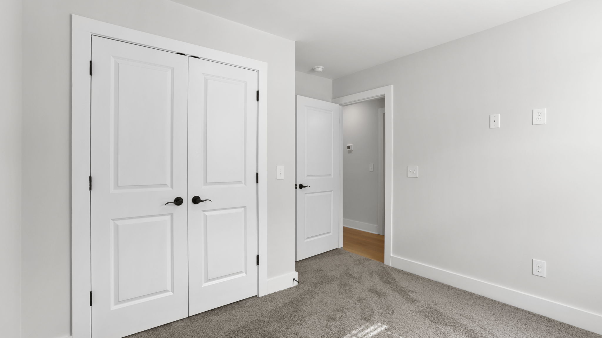 Bedroom with carpet and window.