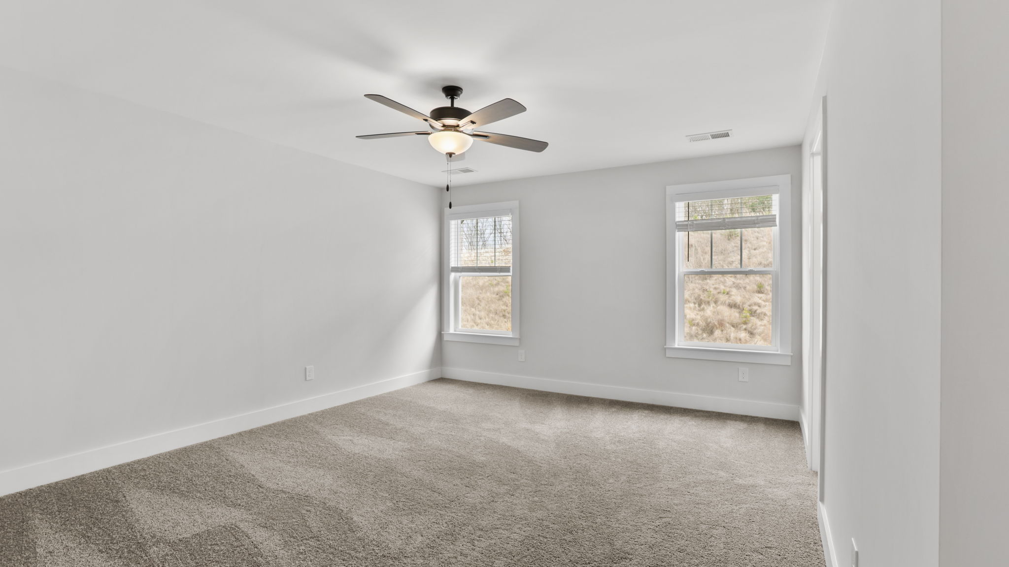 Bedroom with carpet and window.