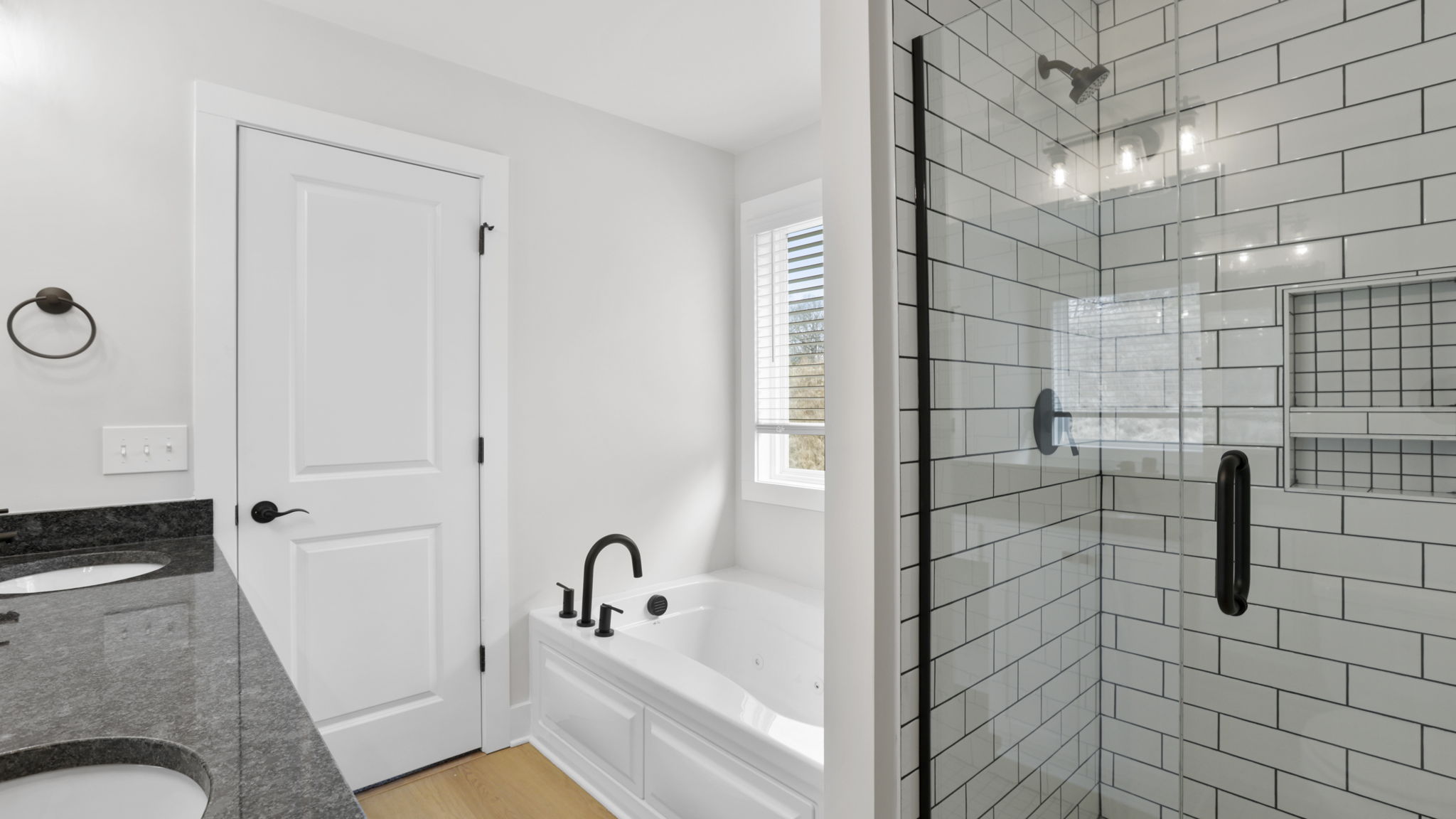 Bathroom with double vanity sink and walk in shower.