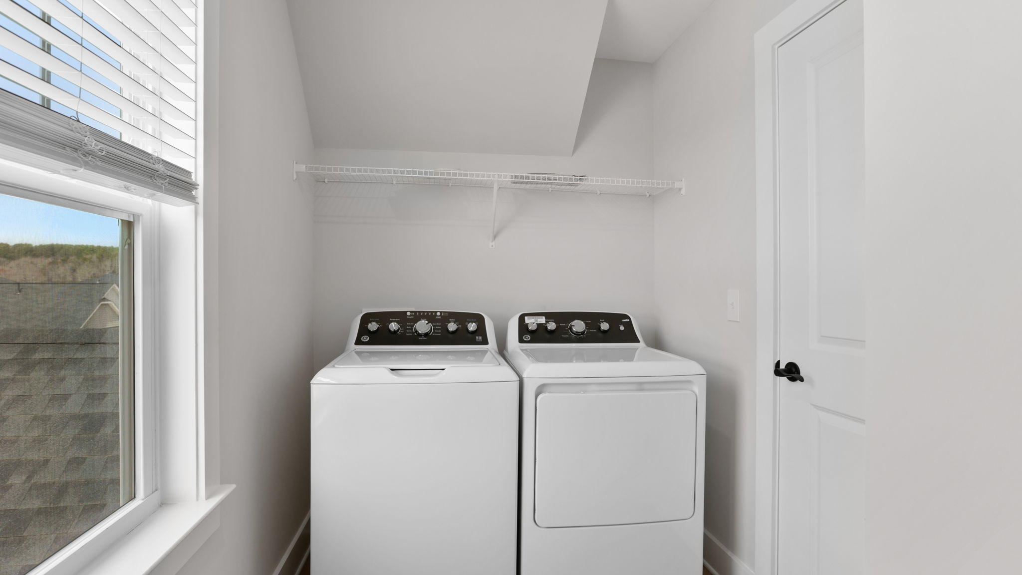 Laundry room with hanging storage racks.