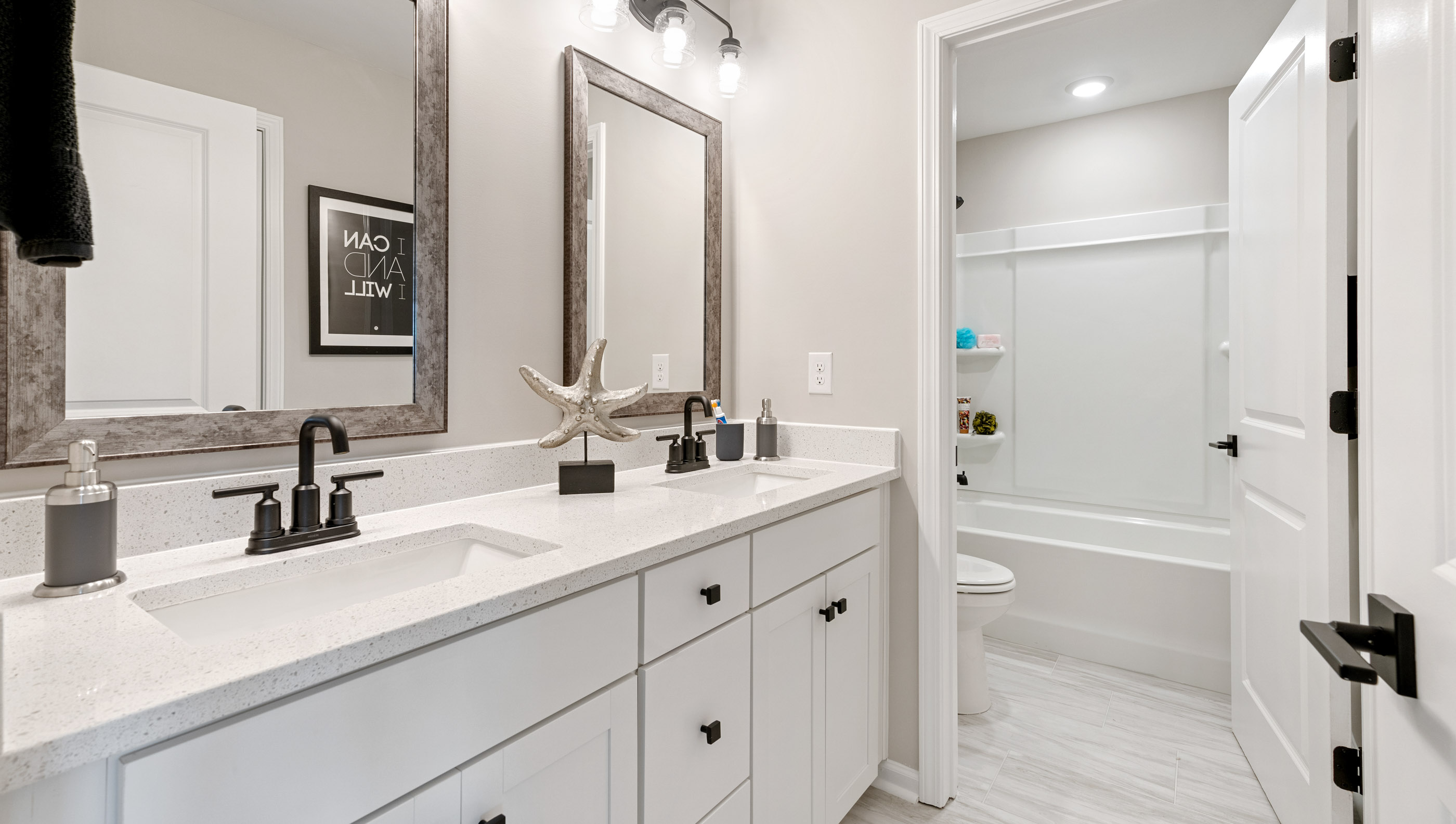 Bathroom with double vanity and tub.