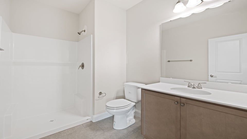 Bathroom with vanity and shower.