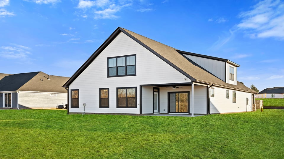 Exterior of home with large backyard.