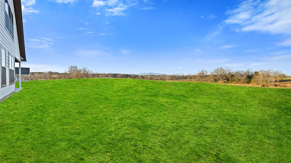 Exterior of home with large backyard.