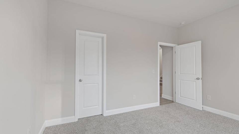 Bedroom with carpet and window.