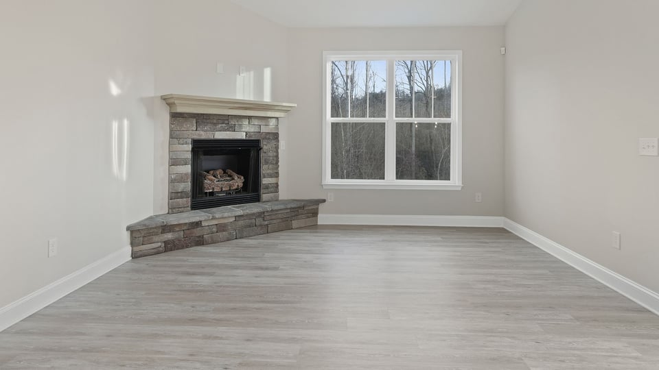 Living room with windows and fireplace.