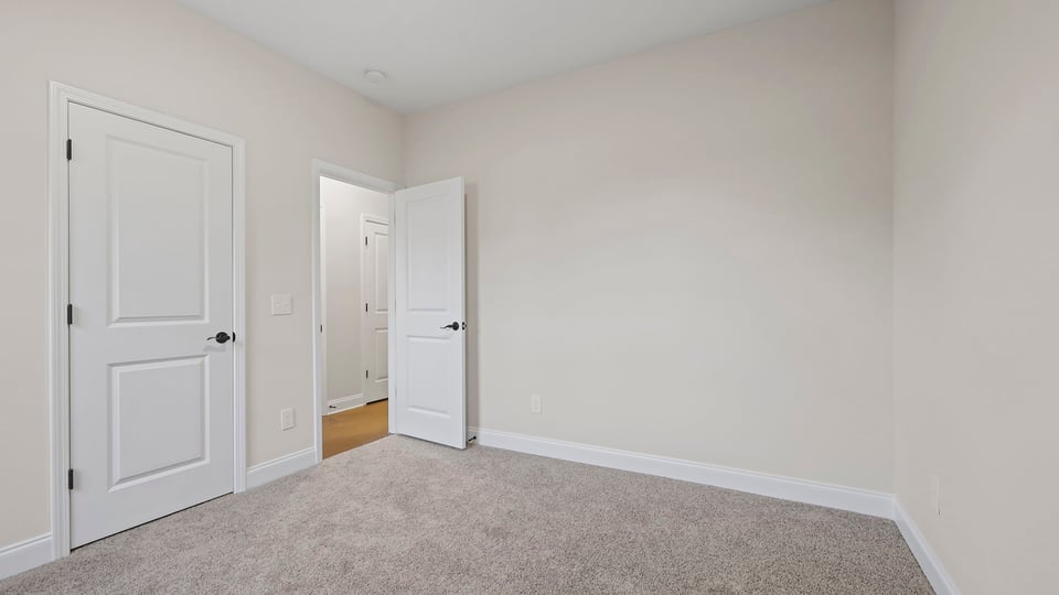 Bedroom with carpet and window.