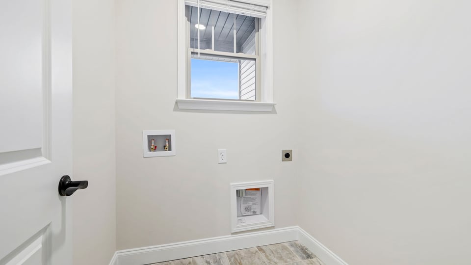 Laundry room with shelf.