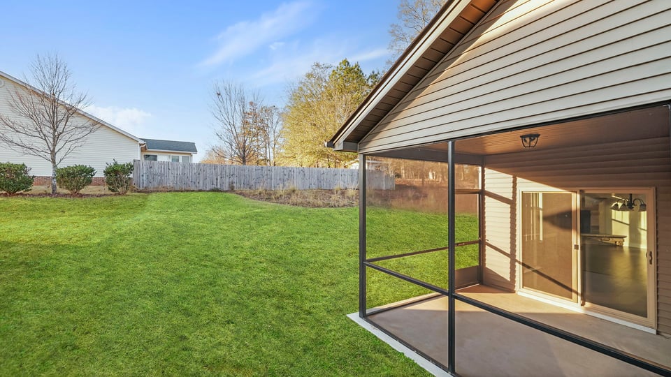 Back exterior with covered patio.