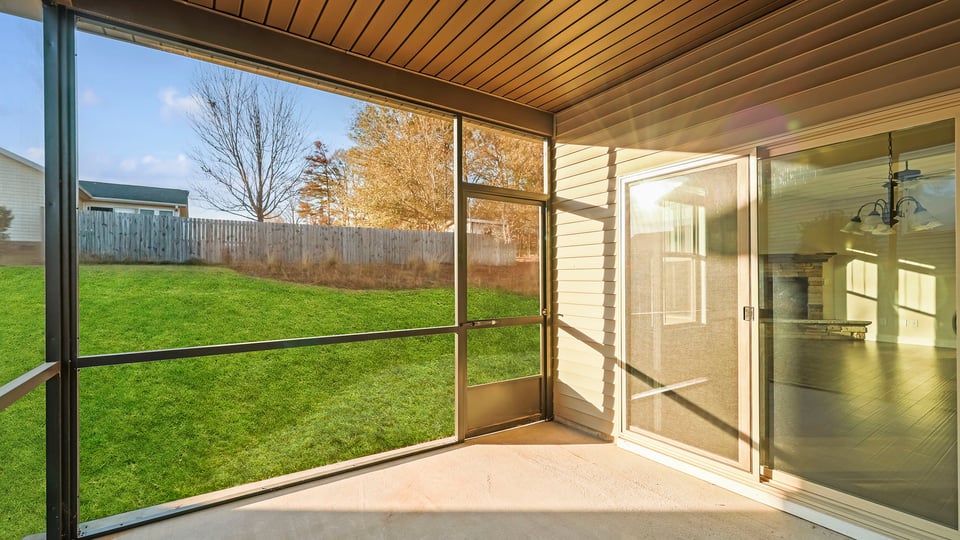 Back exterior with covered patio.
