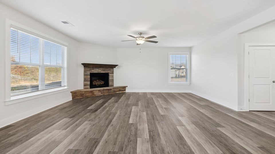 Living area with fireplace and windows.