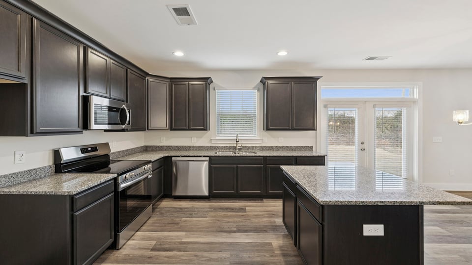 Kitchen with island and cabinets.