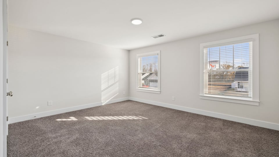 Bedroom with carpet and window.