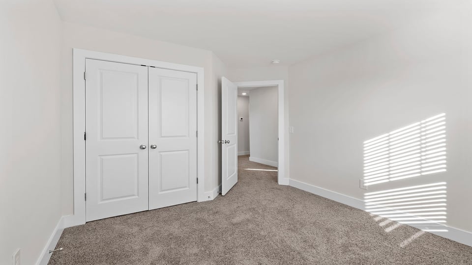 Bedroom with carpet and window.