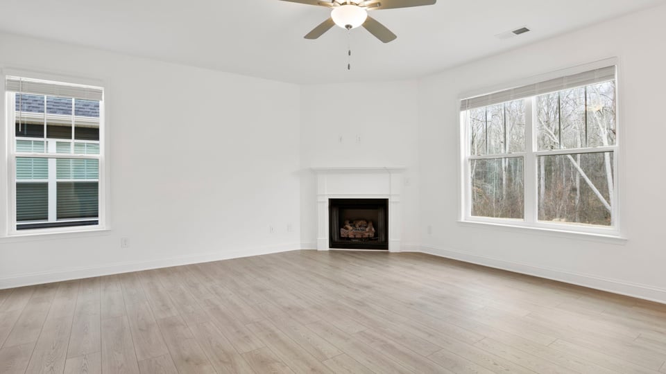 Living area with fireplace and windows.