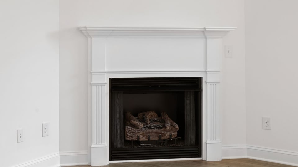 Living area with fireplace and windows.