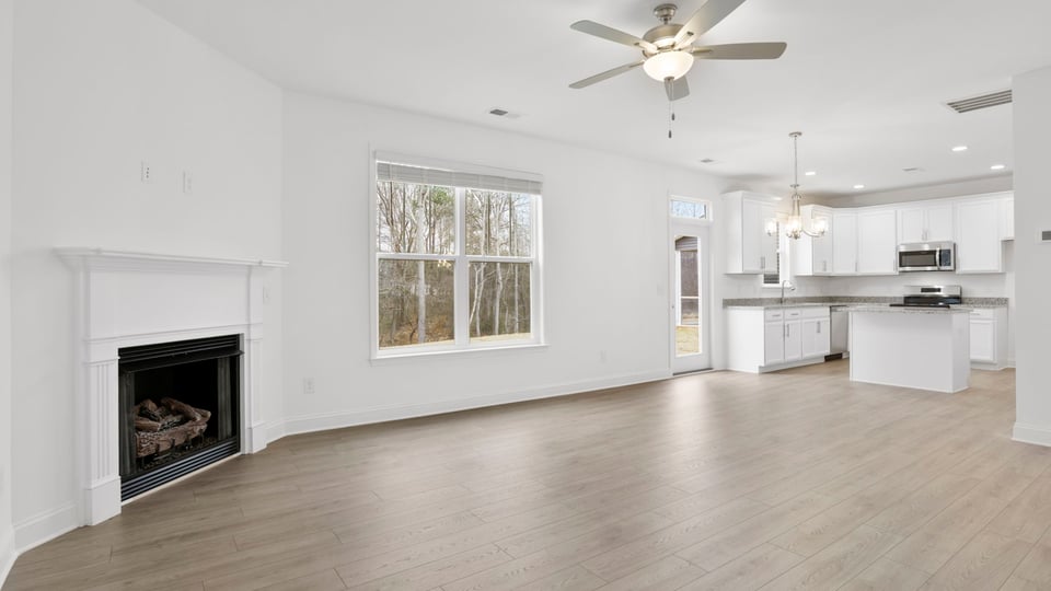 Living area with fireplace and windows.