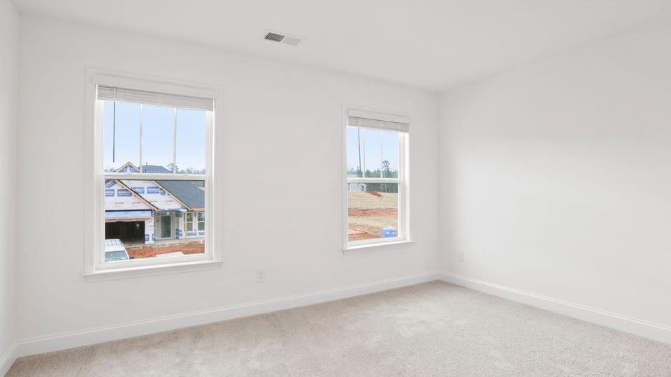 Bedroom with carpet and window.