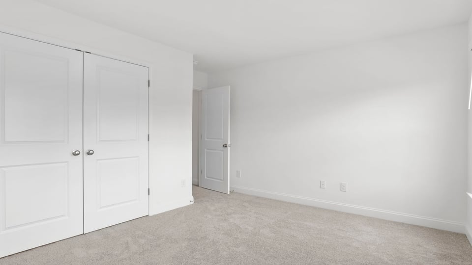 Bedroom with carpet and window.