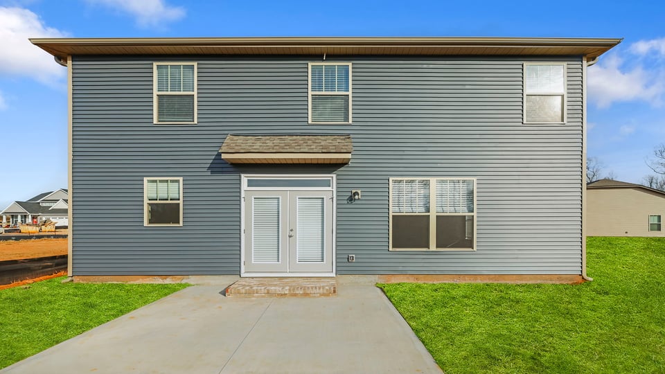 Back exterior with large backyard.