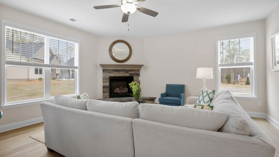 Living room with fireplace and windows.