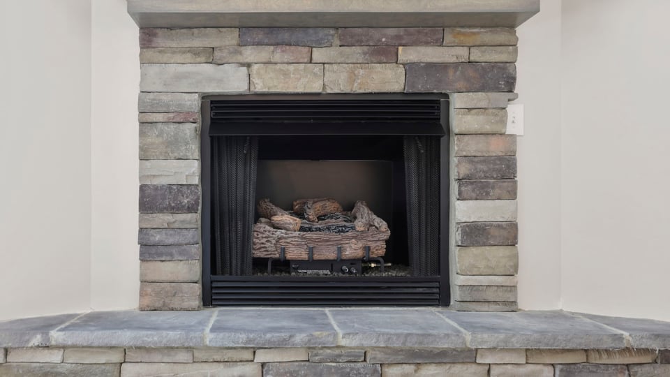 Living room with fireplace and windows.