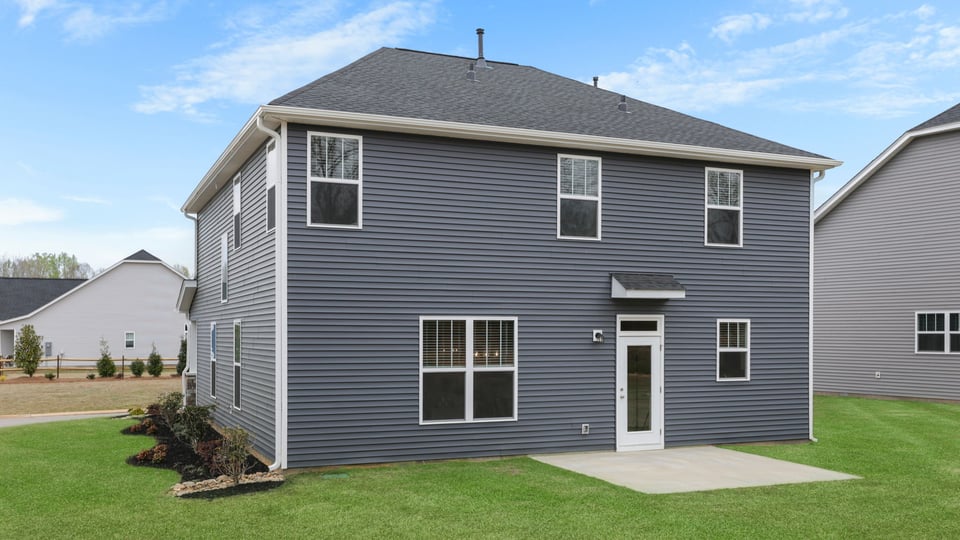 Back exterior with large backyard.