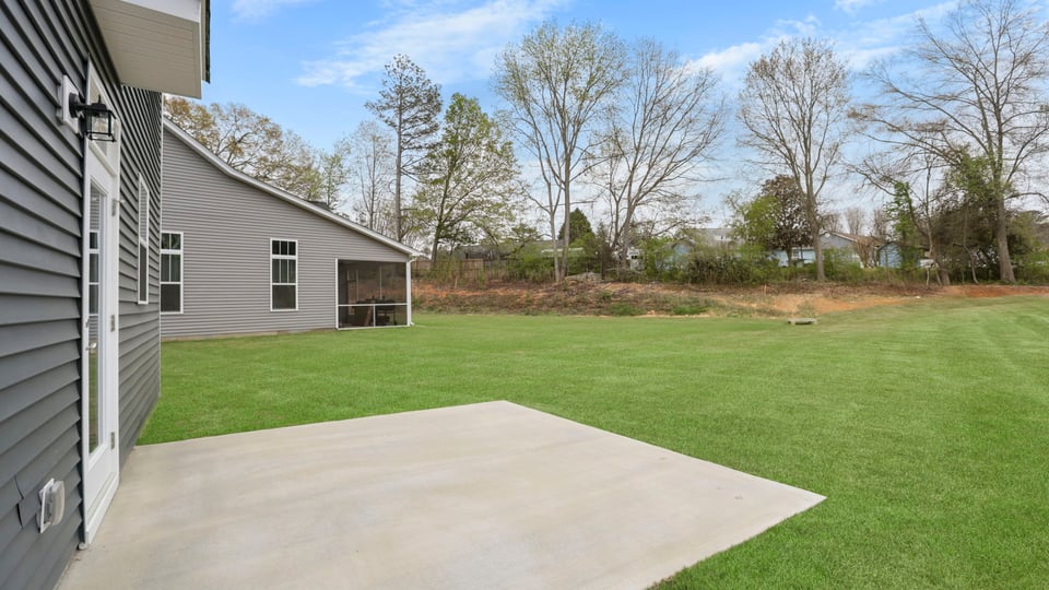 Back exterior with large backyard.