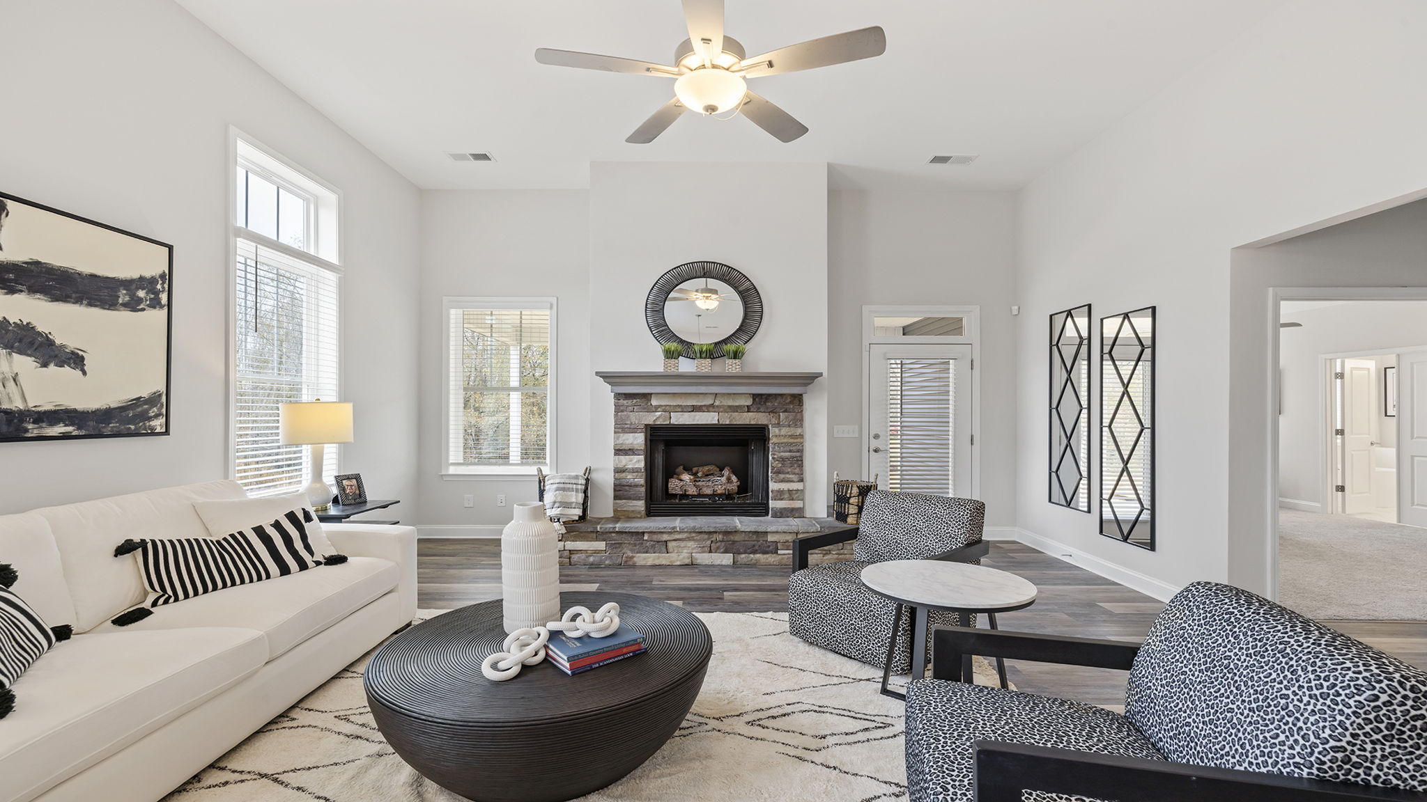 Living room with fireplace and windows.