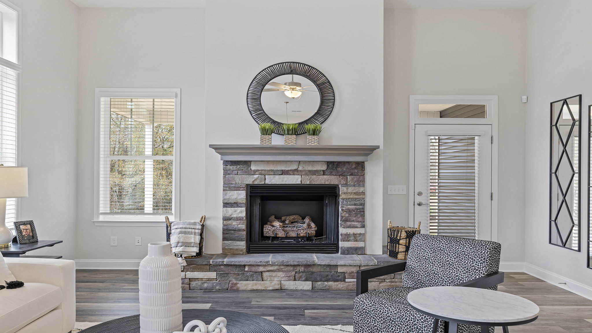 Living room with fireplace and windows.