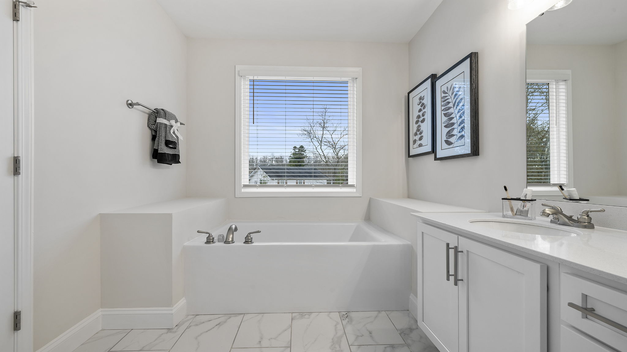 Primary bathroom with double vanity sinks.