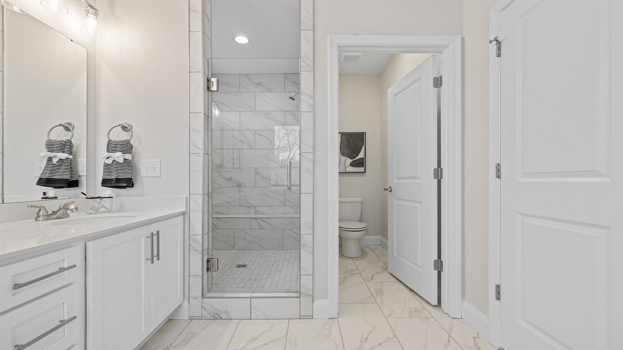 Primary bathroom with double vanity sinks.