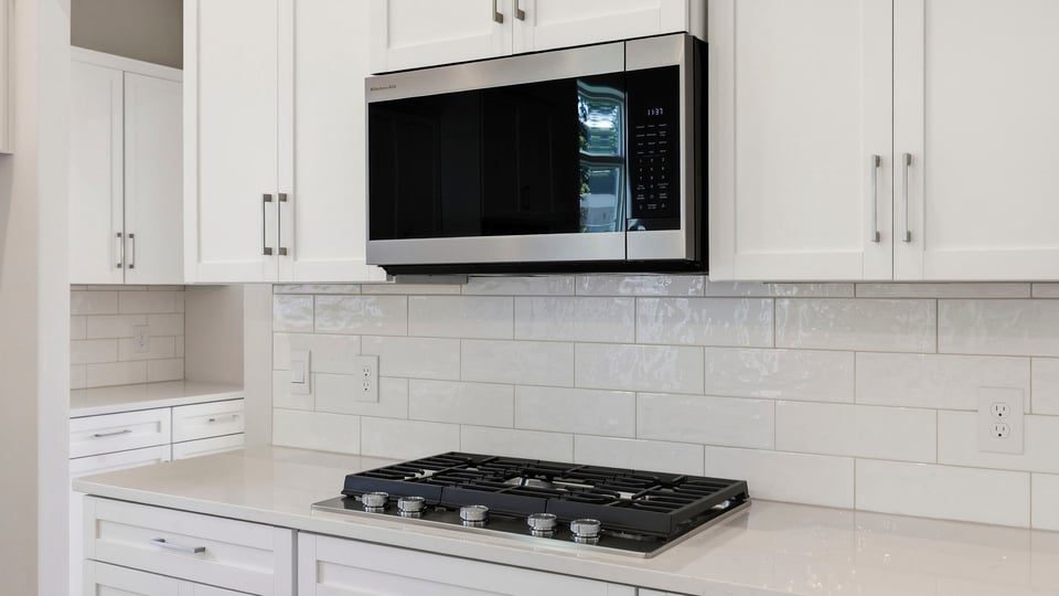 Kitchen with island and cabinets.