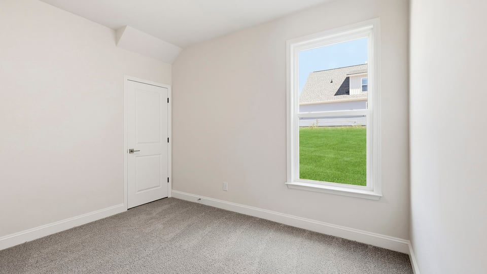 Bedroom with carpet and windows.