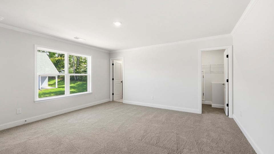 Bedroom with carpet and windows.