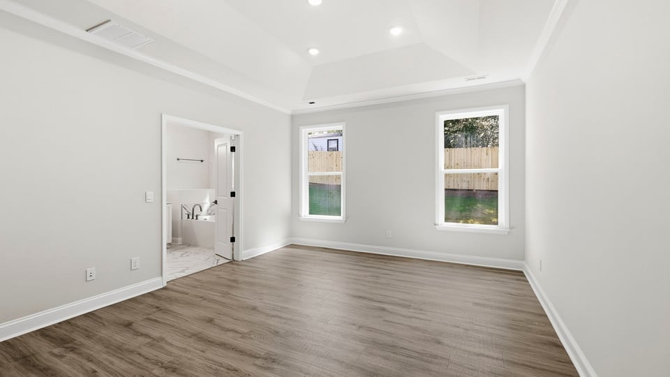 Bedroom with carpet and windows.