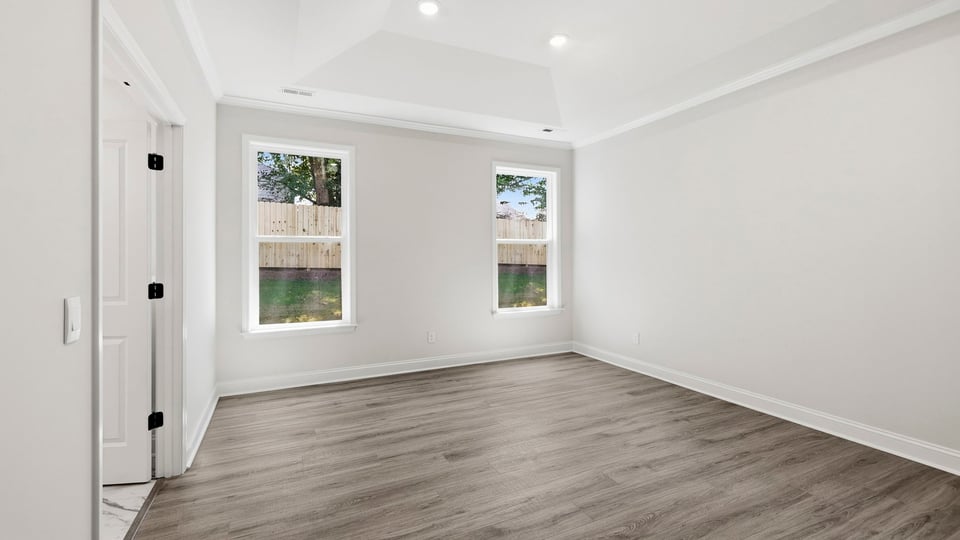 Bedroom with carpet and windows.