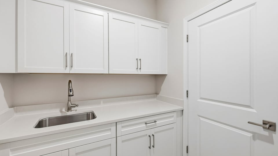 Laundry room with cabinets.