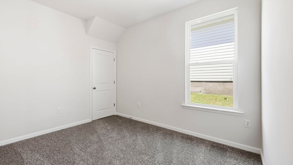 Bedroom with carpet and windows.