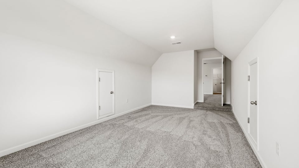 Loft area with carpet and windows.