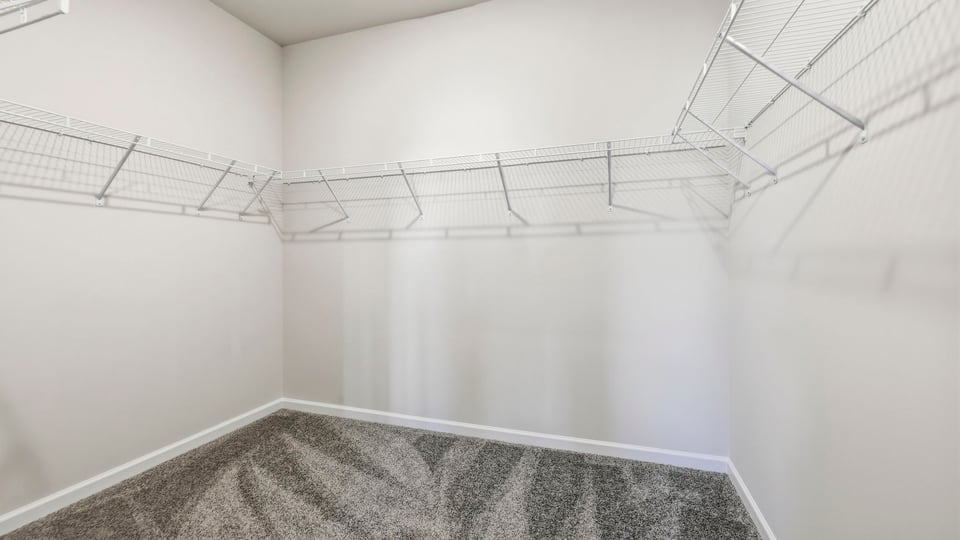 Primary closet with shelf.