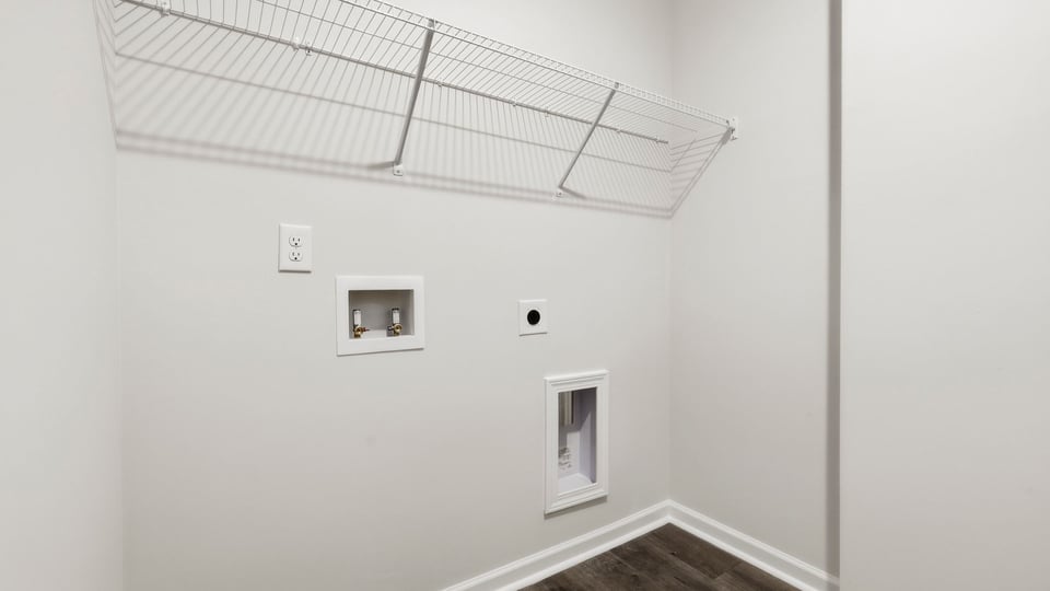 Laundry room with shelf.
