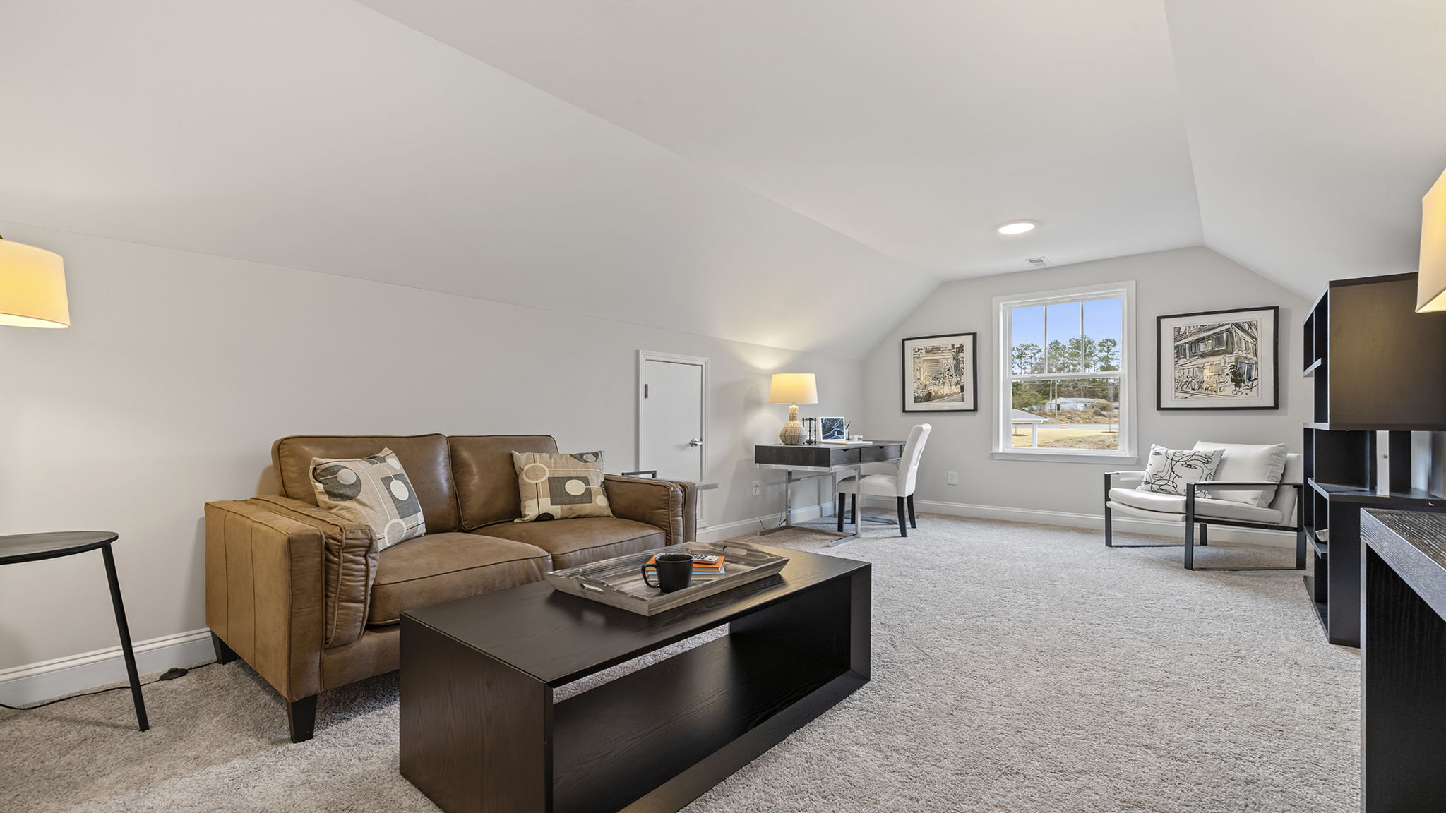 Loft area with carpet and windows.