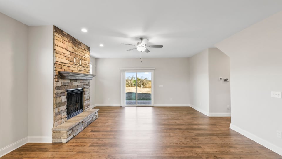 Living area with fireplace and windows.